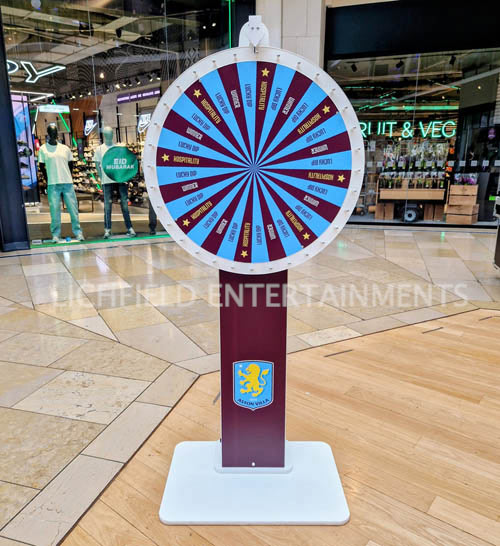Branded freestanding prize wheel at a promotional event, available for hire in Birmingham