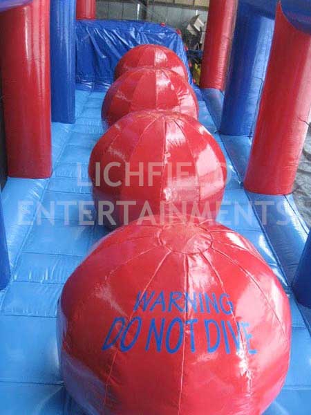 Giant Inflatable Balls - inflatable jumping game for hire. Can you make it across the four balls without falling?